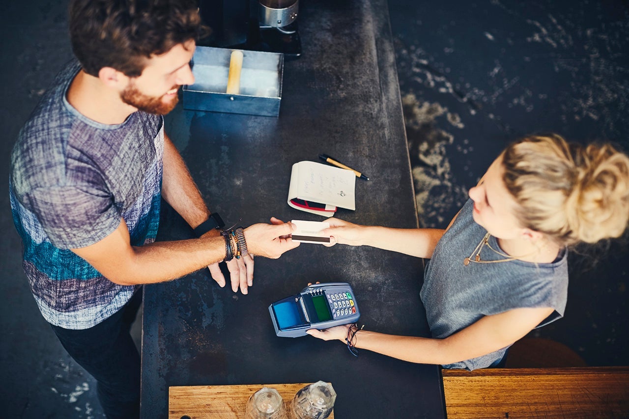 overhead view of a customer paying with a credit card
