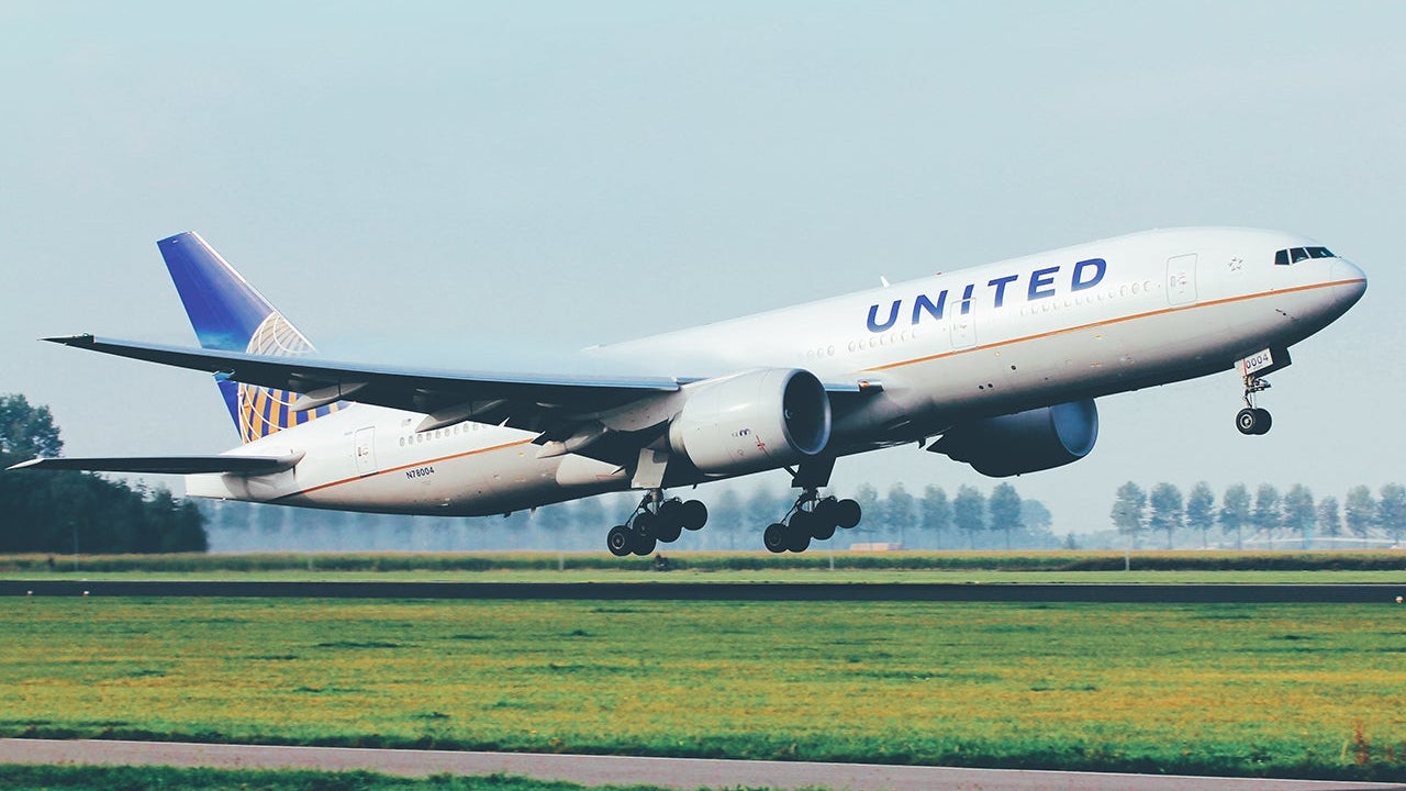 united widebody jet United Airlines Boeing 777 departure from Amsterdam Schiphol Airport