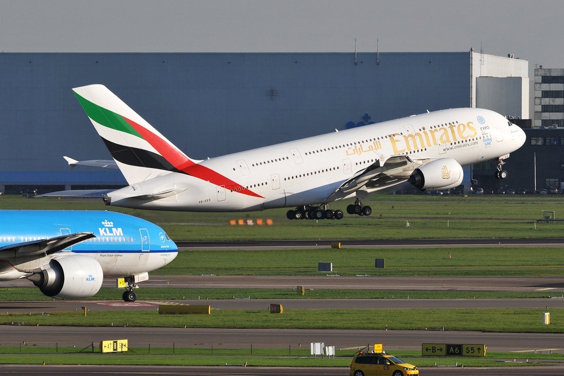 An Emirates Airbus A380 takes off and a KLM 777 taxies, seen from the observation terrace (Photo by Alberto Riva / The Points Guy)