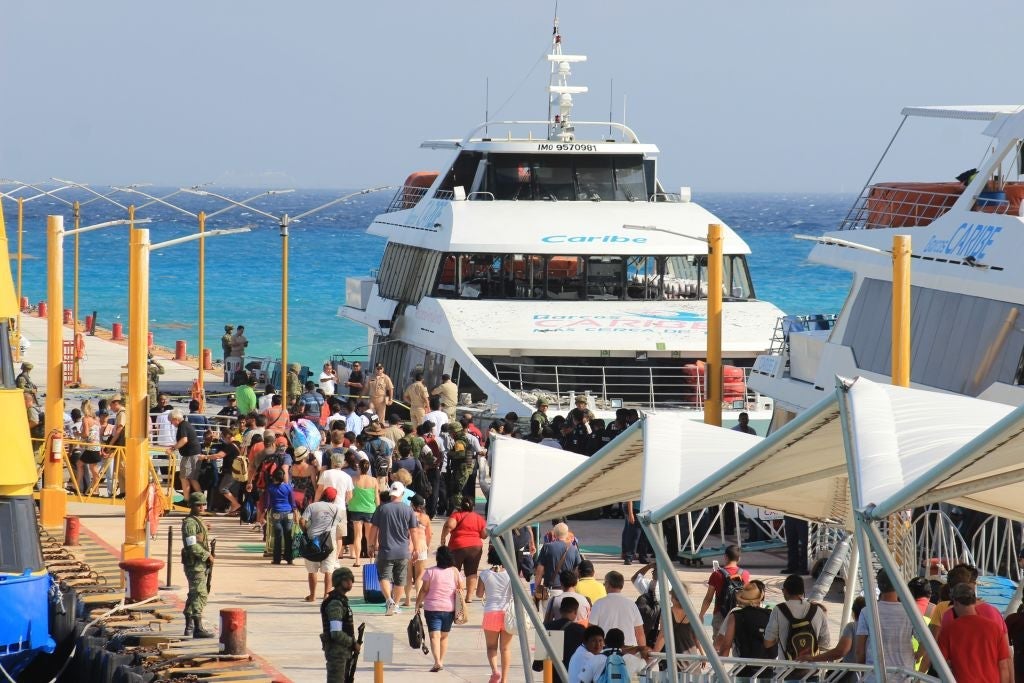 Federal police officers and army soldiers arrive at the dock where an explosion occurred on a ferry in Playa del Carmen, Quintana Roo state, Mexico on February 21, 2018.An explosion, apparently caused by a mechanical failure, on a ferry that runs between the touristic Playa del Carmen and the island of Cozumel, in the Mexican Caribbean, left three Canadians and 15 Mexicans injured on Wednesday, local authorities reported. / AFP PHOTO / STR (Photo credit should read STR/AFP/Getty Images)