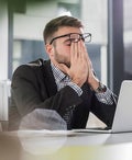 man exasperated at computer