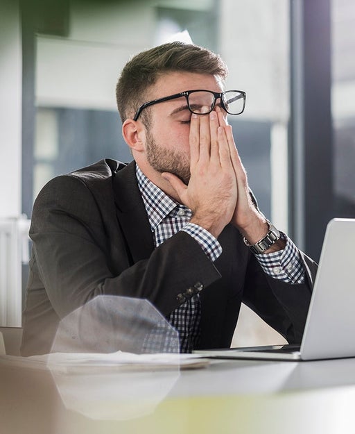 man exasperated at computer