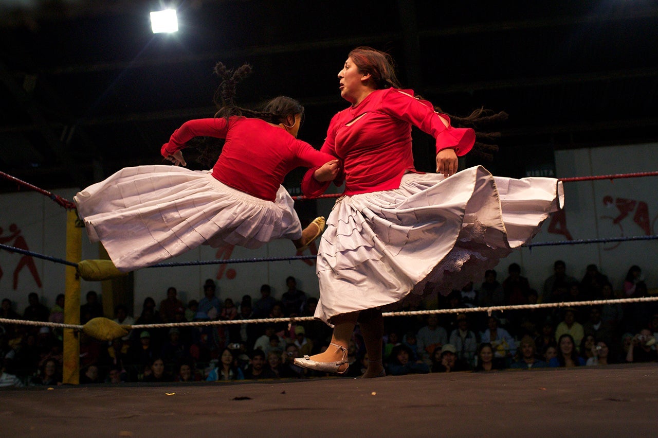 Cholita wrestler Martha La Altena (right) fights with a male wrestler dressed as a Cholita during the 'Titans of the Ring' wrestling group's performance at El Alto's Multifunctional Centre. Bolivia. (Photo by Tim Clayton/Corbis via Getty Images)