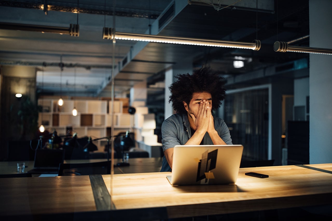 Man working on laptop at desk - reader mistake story