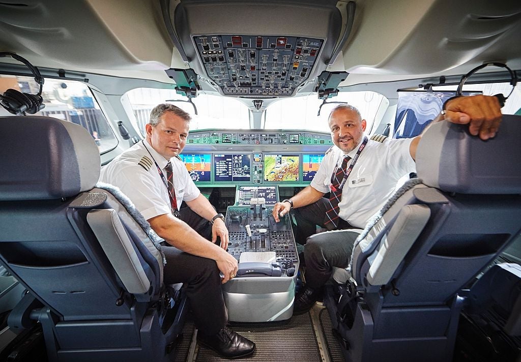 Pilots pose inside the cockpit of Swiss International Air Lines' new Bombardier CS 100 passenger jetliner during its presentation at Zurich Airport in Zurich on July 6, 2016. Swiss International Air Lines' new Bombardier CS 100 jetliner is the first rolled out aircraft of the Canadian Bombardier Commercial Aircraft's new jetliner C-Series aircrafts. / AFP / MICHAEL BUHOLZER (Photo credit should read MICHAEL BUHOLZER/AFP/Getty Images)