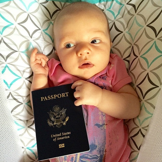Baby S with her passport at 1 month old