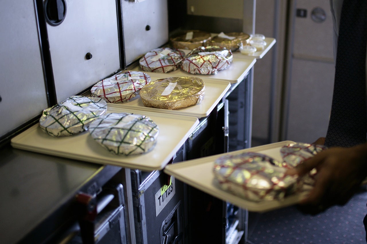 Food service in the galley inside a commercial passenger 747-400 airplane. (Photo by Brooks Kraft LLC/Corbis via Getty Images)