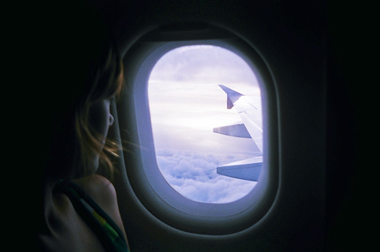 A person looks out a plane window