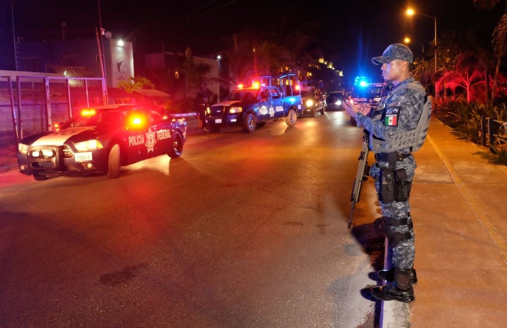A Federal police officer stands on guard at the area where at least five people including a ministerial police officer were killed in Puerto Juarez, Cancun, Quintana Roo State, Mexico, on July 27, 2018. - A journalist was murdered Tuesday in southeast Mexico, not far from tourist hotspot Cancun, the government said -- the seventh such killing this year in one of the world's most dangerous countries for reporters (Photo by STR / AFP)        (Photo credit should read STR/AFP/Getty Images)
