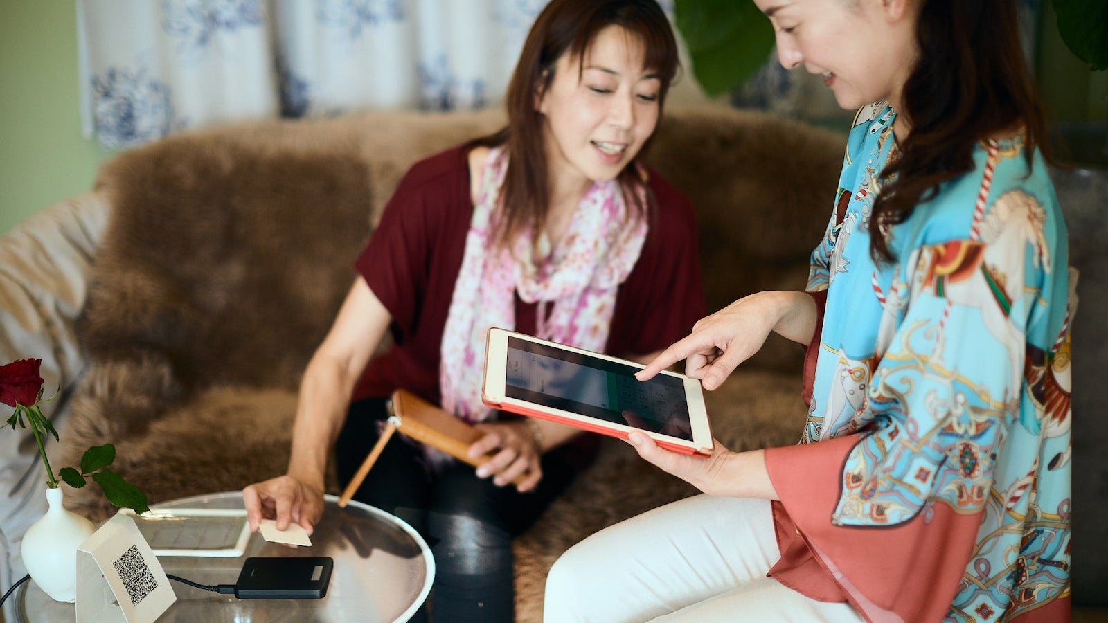 Woman paying with tablet app for accounting at shop