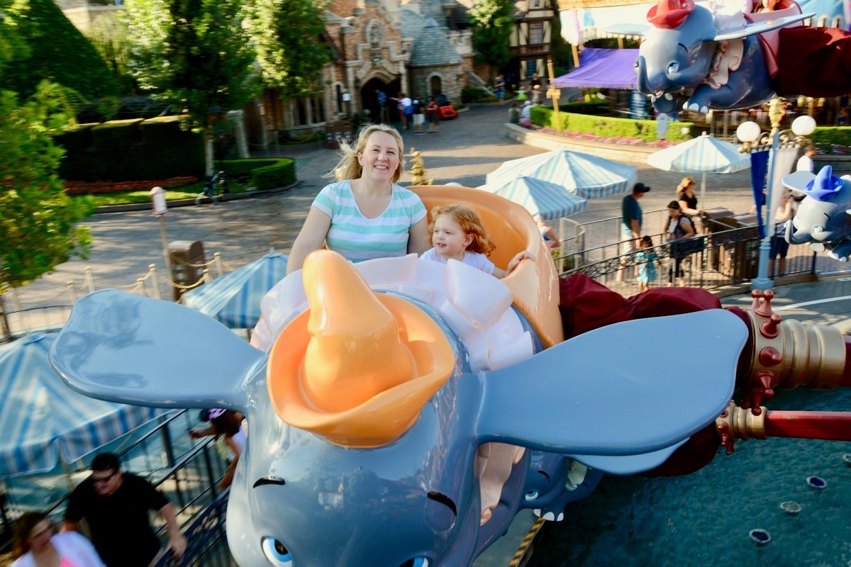Mom and daughter riding on Dumbo in Disneyland