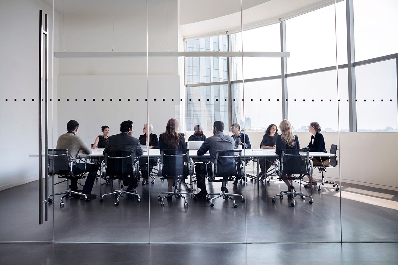 Colleagues at business meeting in conference room. (Photo by FangXiaNuo/Getty Images)
