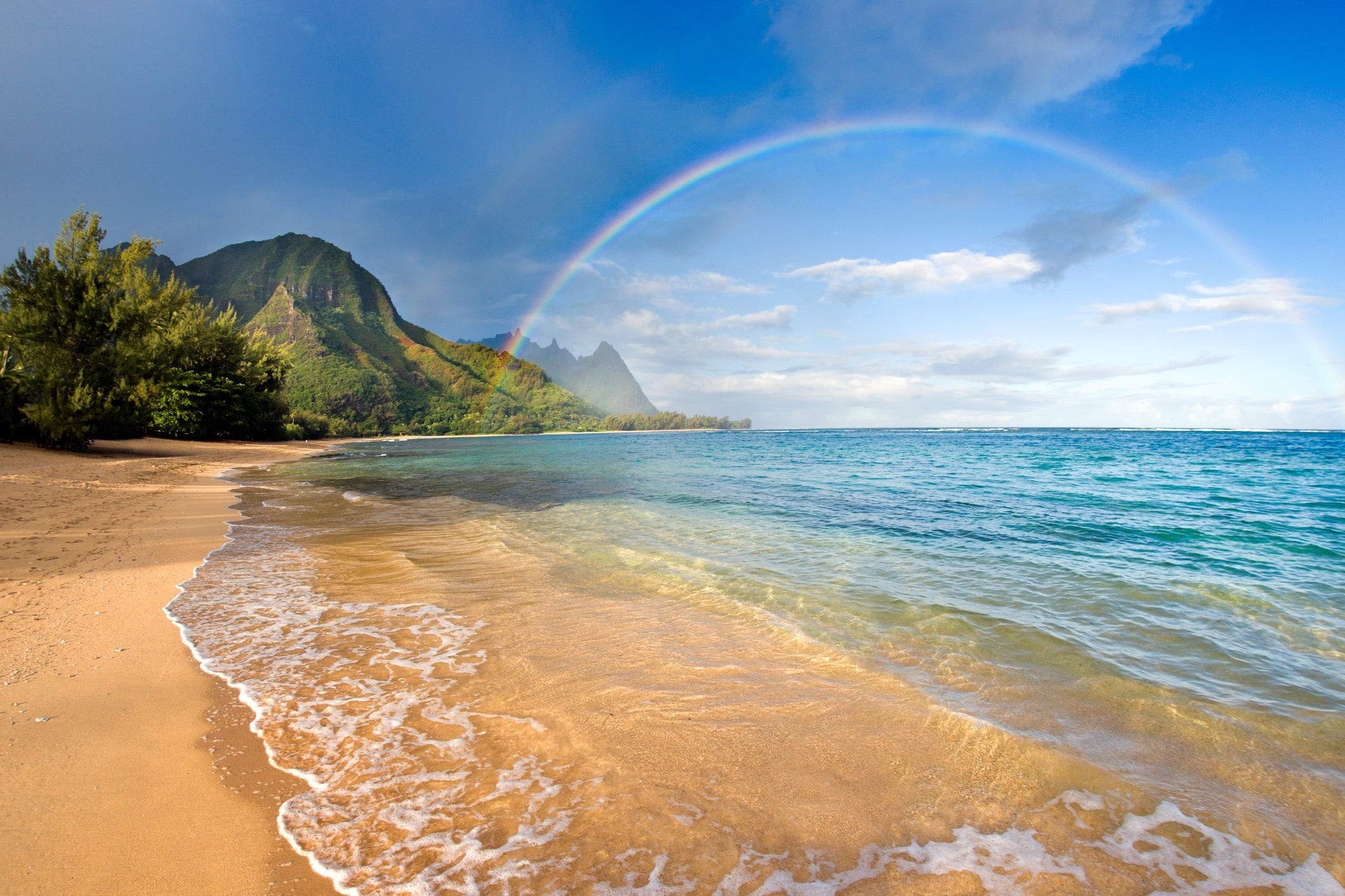 Rainbow over Tunnels Beach on north shore of Kauai, Hawaii (Getty Images)