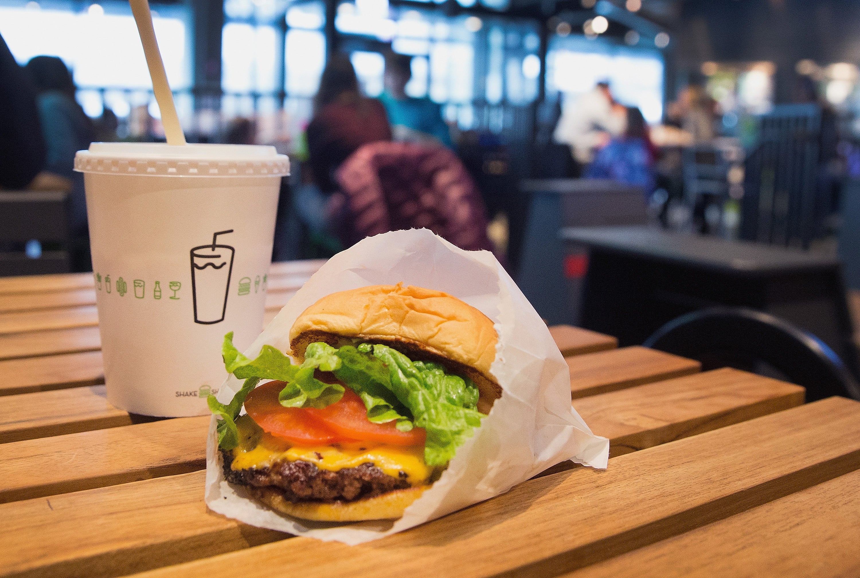 CHICAGO, IL - JANUARY 28: In this photo illustration a cheeseburger and drink is served up at a Shake Shack restaurant on January 28, 2015 in Chicago, Illinois. The burger chain, with currently has 63 locations, is expected to go public this week with an IPO priced between $17 to $19 a share. The company will trade on the New York Stock Exchange under the ticker symbol SHAK. (Photo Illustration by Scott Olson/Getty Images)