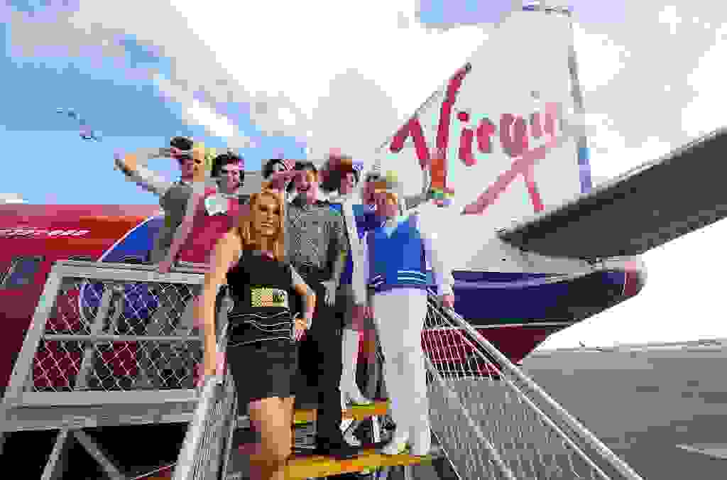 Crew and guests on board a Sydney bound Virgin flight on February 26, 2010 in Melbourne, Australia. In celebration of The Sydney Gay and Lesbian Mardi Gras, one of the biggest events on the Sydney calendar, Virgin Blue has dedicated an entire commercial flight from Melbourne to Sydney to the glitz and glamour of this annual event.