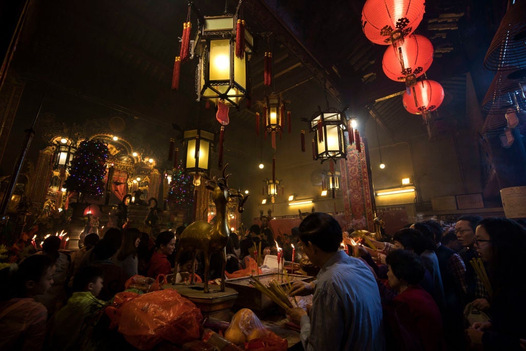 HONG KONG, HONG KONG SAR, CHINA - 2017/03/24: Man Mo Temple or Man Mo Miu is a temple in Hong Kong that reveres both the God of Literature and the God of War each of whom were worshipped by ambitious students hoping to succeed in the civil examinations of Imperial China. Man Mo Temple was built in 1847 and is known for its giant hanging incense coils. Its ambiance is a pleasant contrast with the hectic pace of the nearby shopping and financial district of Central Hong Kong. (Photo by John S Lander/LightRocket via Getty Images)