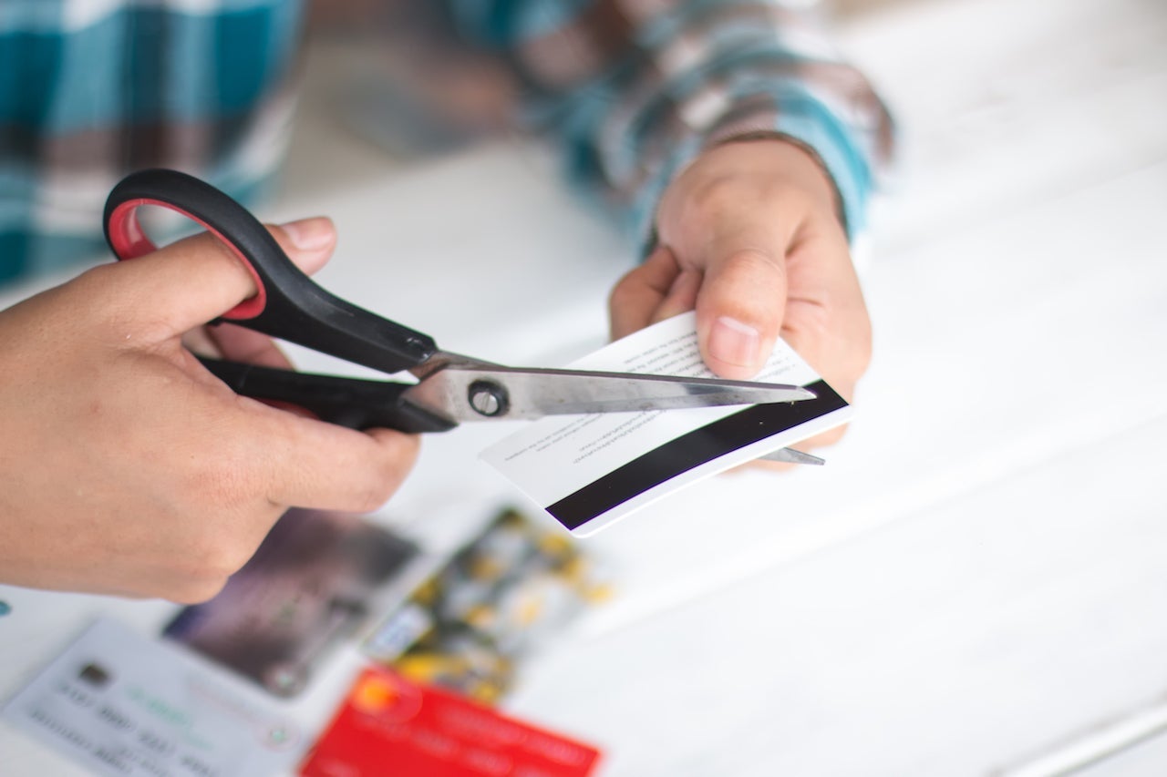 cutting up credit card with scissors