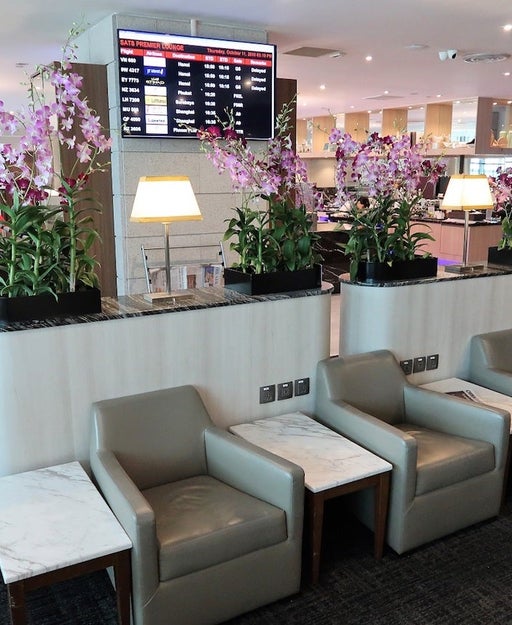 seating and flower arrangements at an empty airport lounge