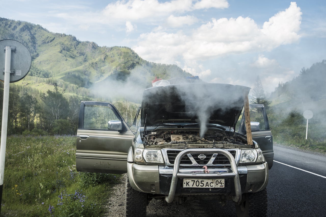 steam pours out of a car's engine block