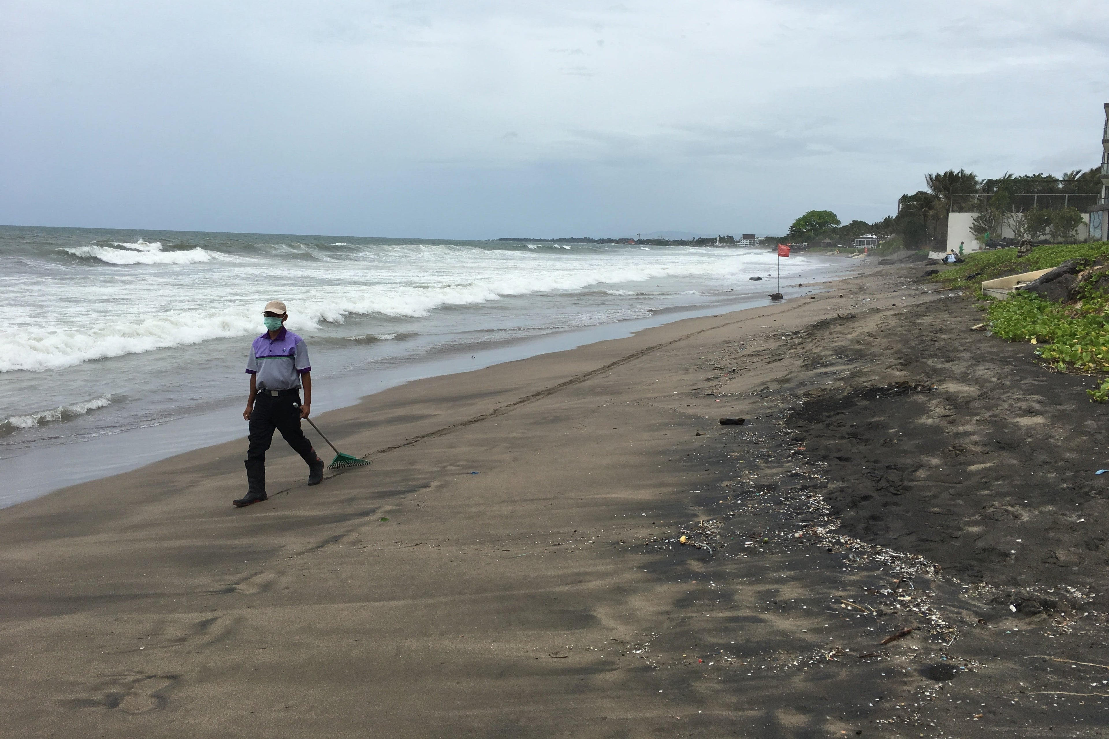 Cleaning up Seminyak Beach in Bali is a big job, and this guy didn't seem up for it.