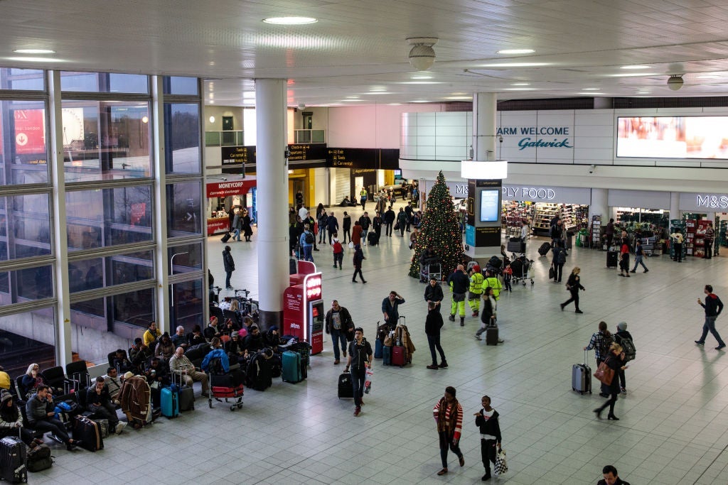 LONDON, ENGLAND - DECEMBER 21: Passengers wait in the South Terminal building at London Gatwick Airport after flights resumed today on December 21, 2018 in London, England. Authorities at Gatwick have reopened the runway after drones were spotted over the airport on the night of December 19. The shutdown sparked a succession of delays and diversions in the run up to the Christmas getaway, in what authorities have called a "deliberate act" to disrupt the airport. Police continue their search for the drone operators responsible. (Photo by Jack Taylor/Getty Images)