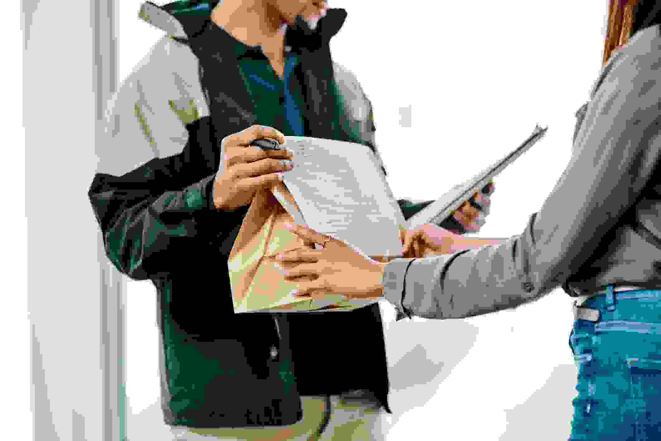 Closeup shot of a courier making a delivery to a customer (image by Getty Images / katleho Seisa)