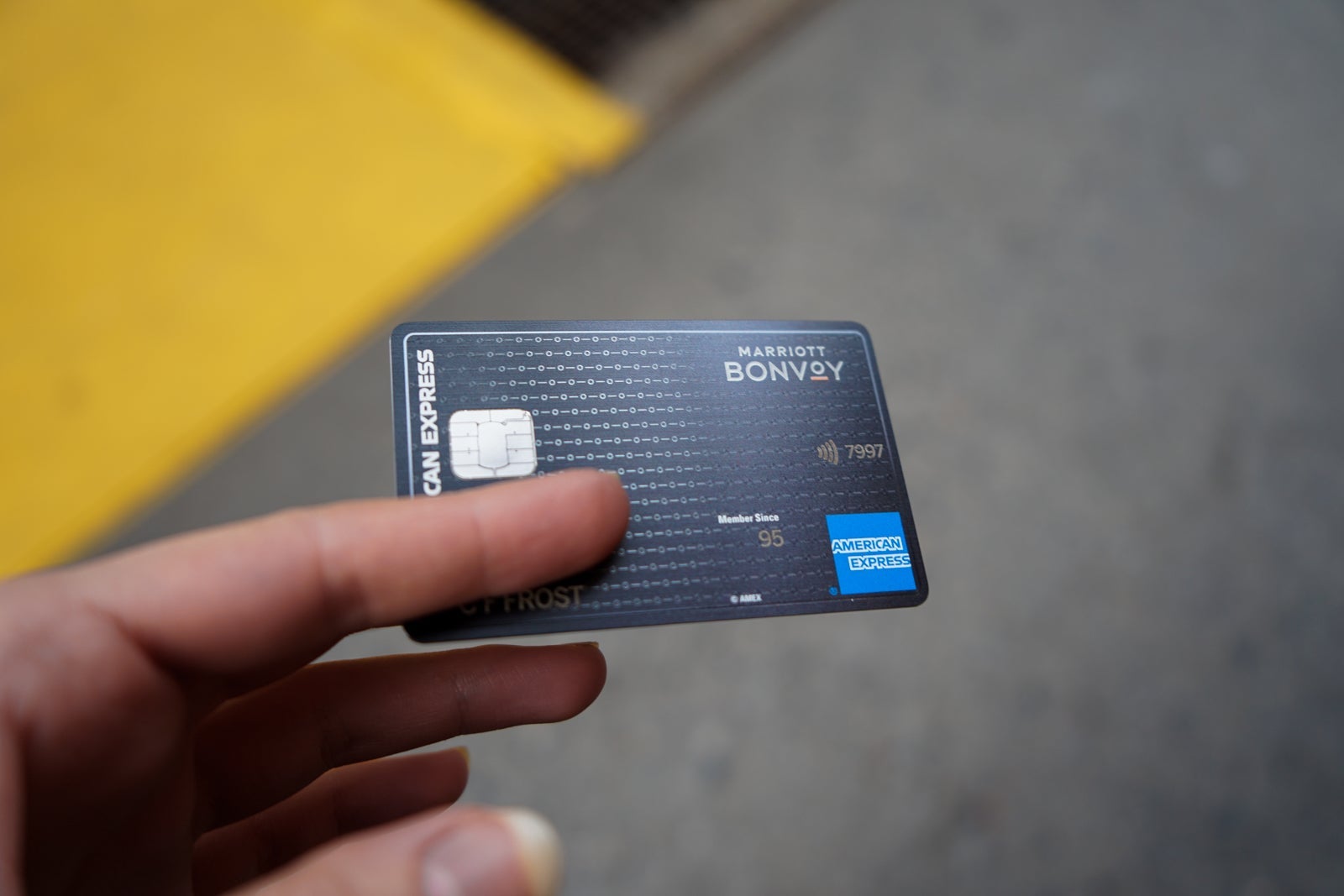 a hand holds a credit card