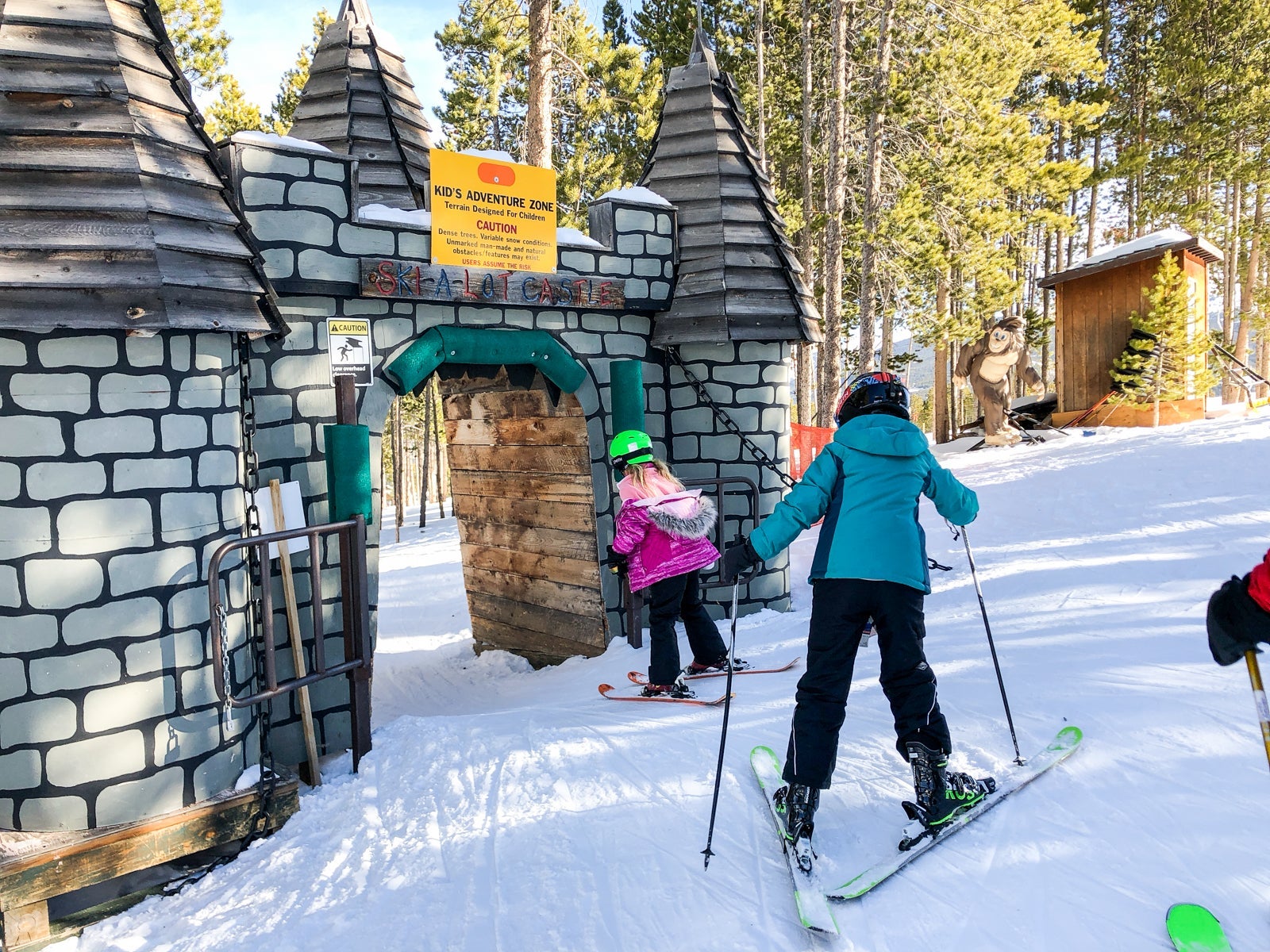Two people skiing through the kid's adventure zone at Breckenridge, Colorado