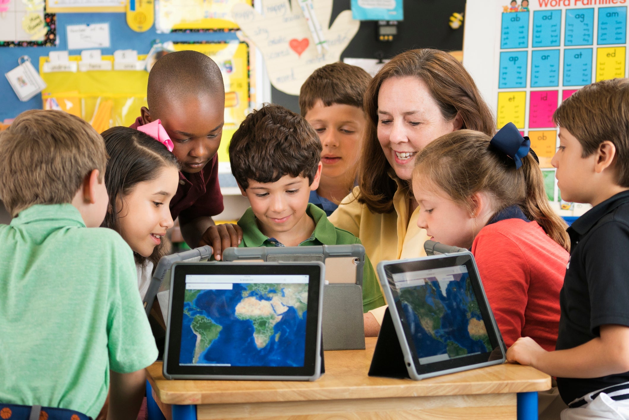 kids with maps in a classroom