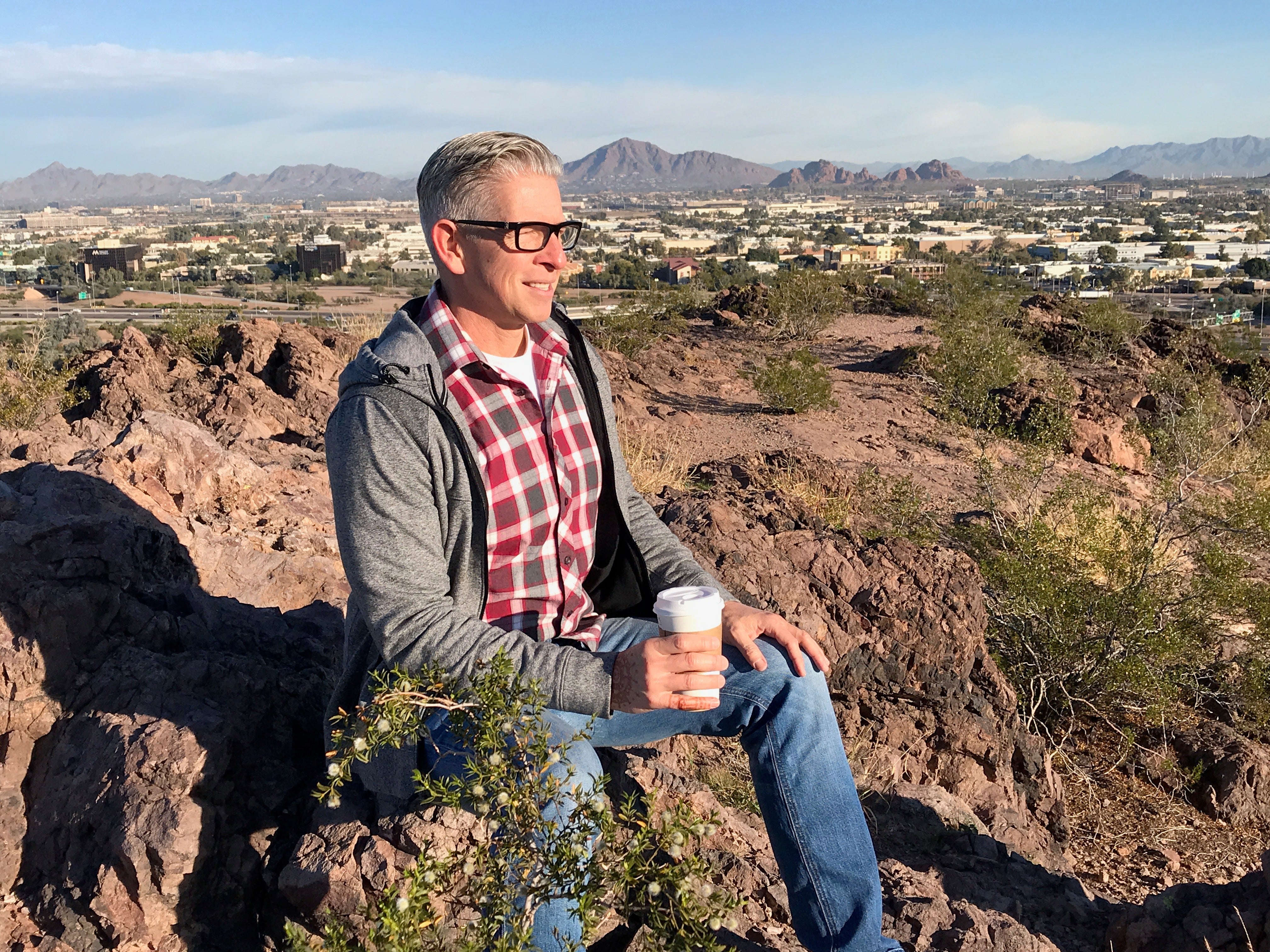 man with view from top of The Buttes in Tempe Arizona