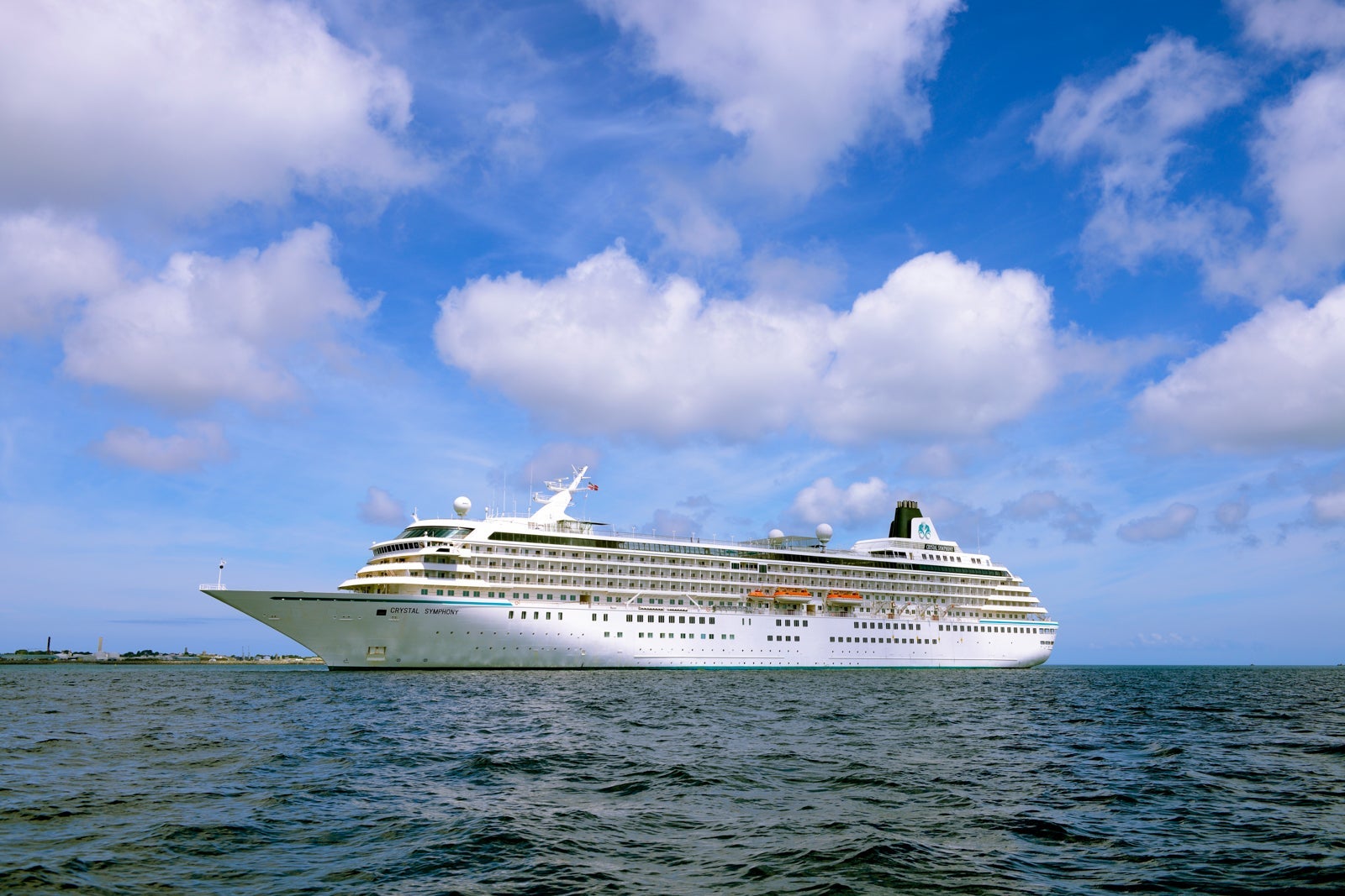 Crystal Symphony cruise ship anchored in the ocean with blue sky overhead