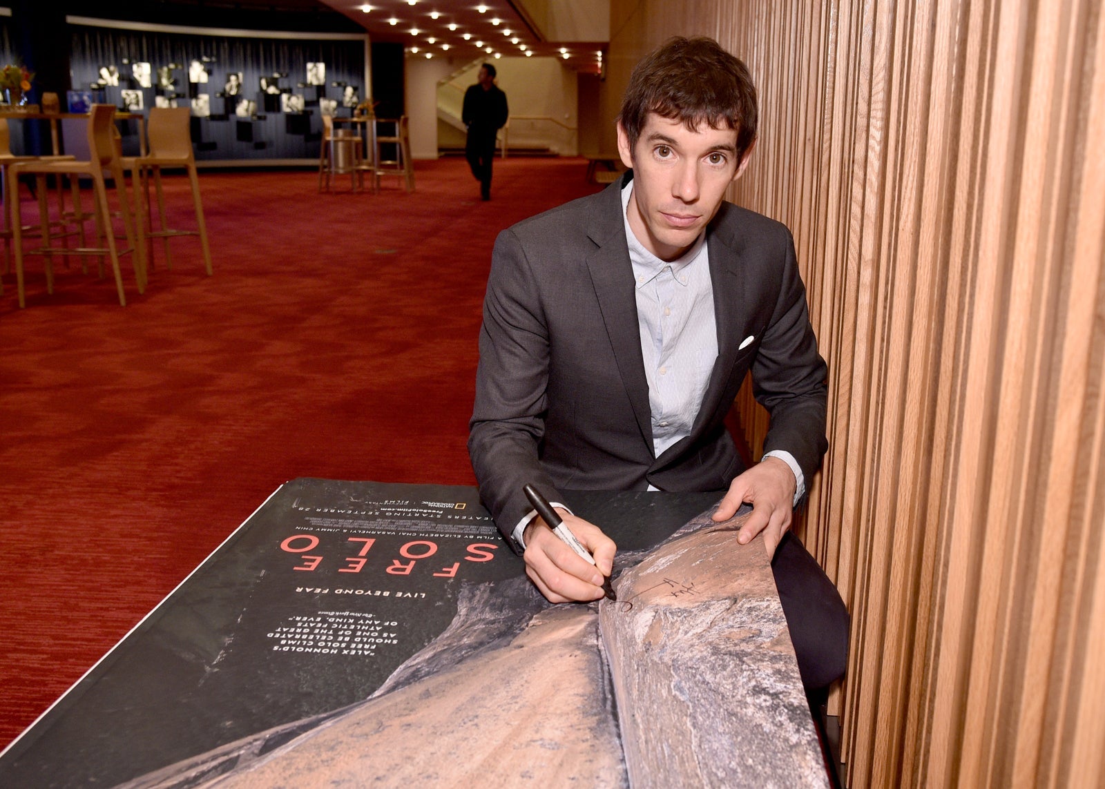 Featured Free Soloist Alex Honnold signs posters during the New York City premiere of National Geographic Documentary Films' "Free Solo." (Photo by Bryan Bedder/Getty Images for National Geographic)
