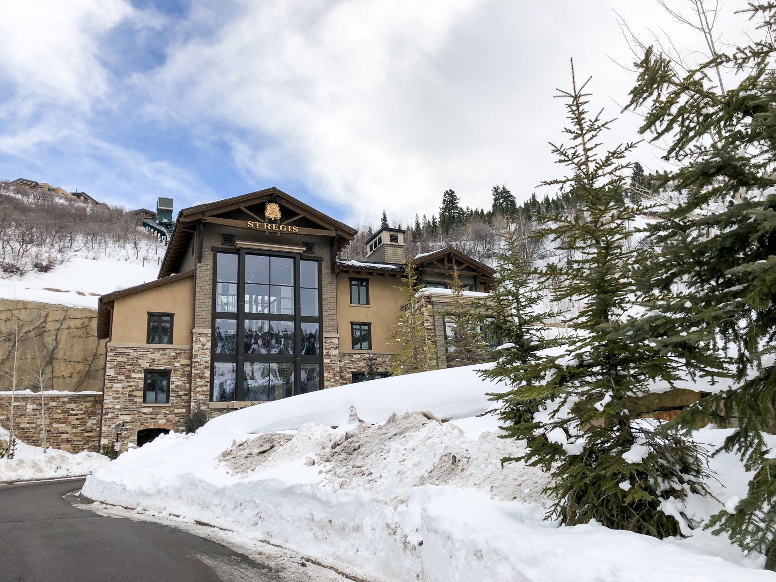 a hotel building is surrounded by snowy mountains