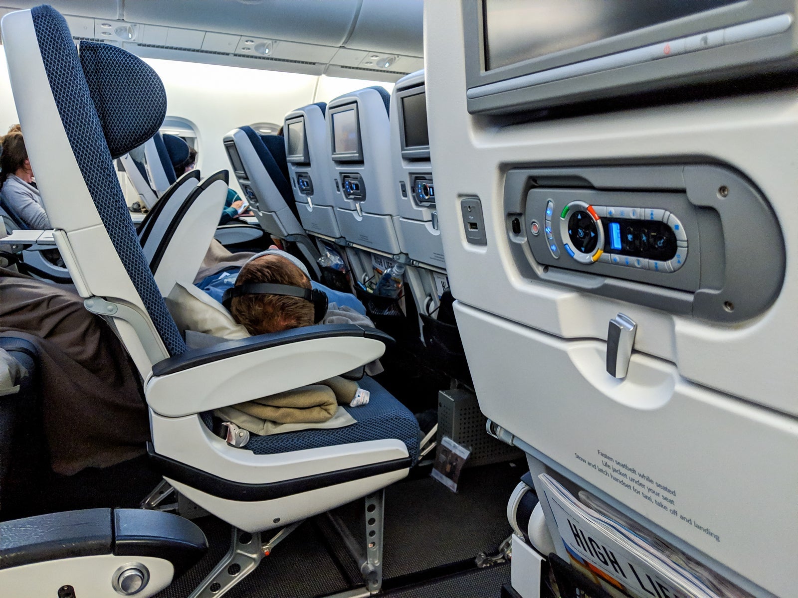 This man lucked into a row to himself, so he slept across the four seats.