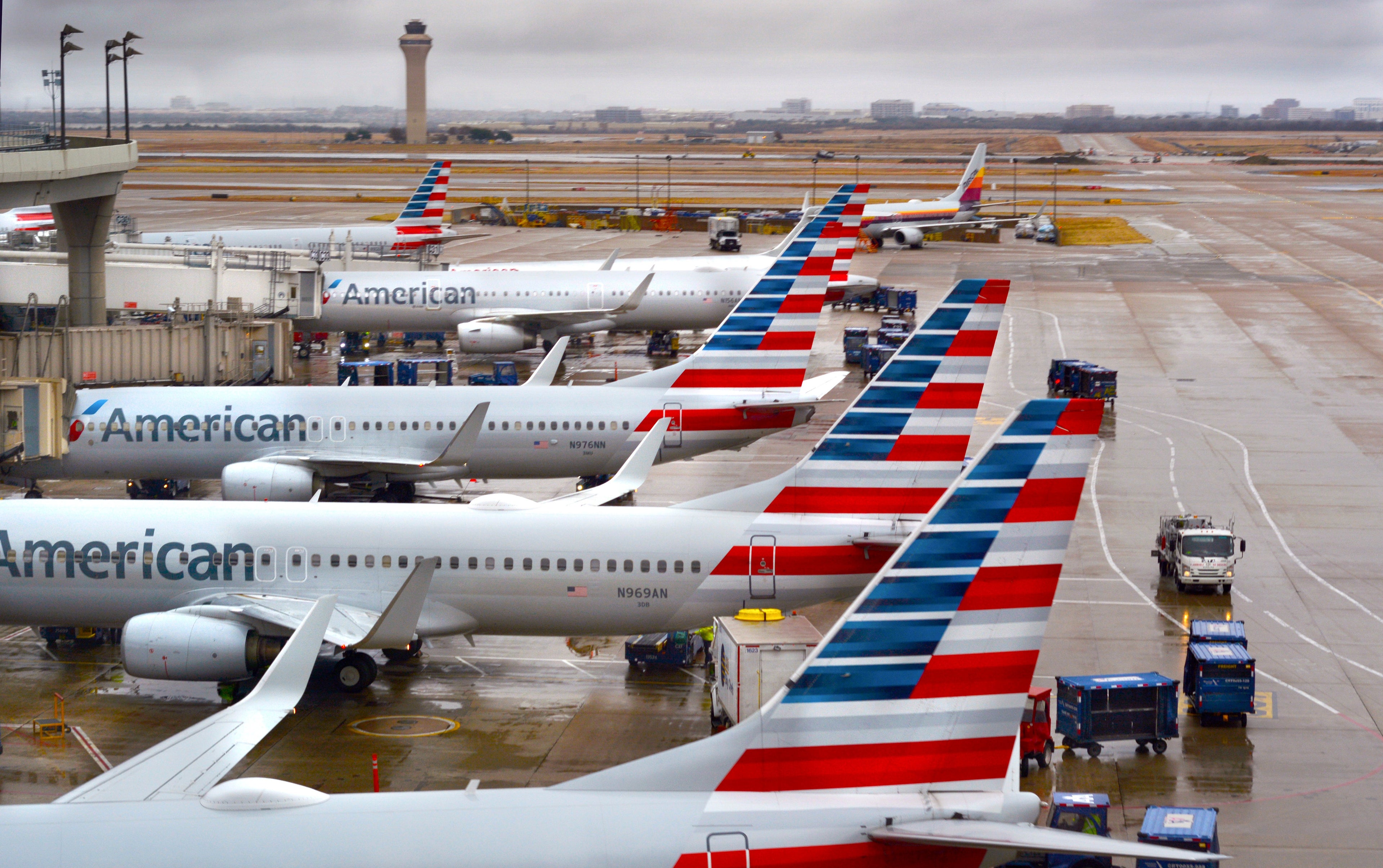 DALLAS, TEXAS - DECEMBER 8, 2018: American Airlines passenger jets parked at their gates on a rainy morning at Dallas/Fort Worth International Airport which serves the Dallas/Fort Worth, Texas, metroplex area in Texas. (Photo by Robert Alexander/Getty Images)