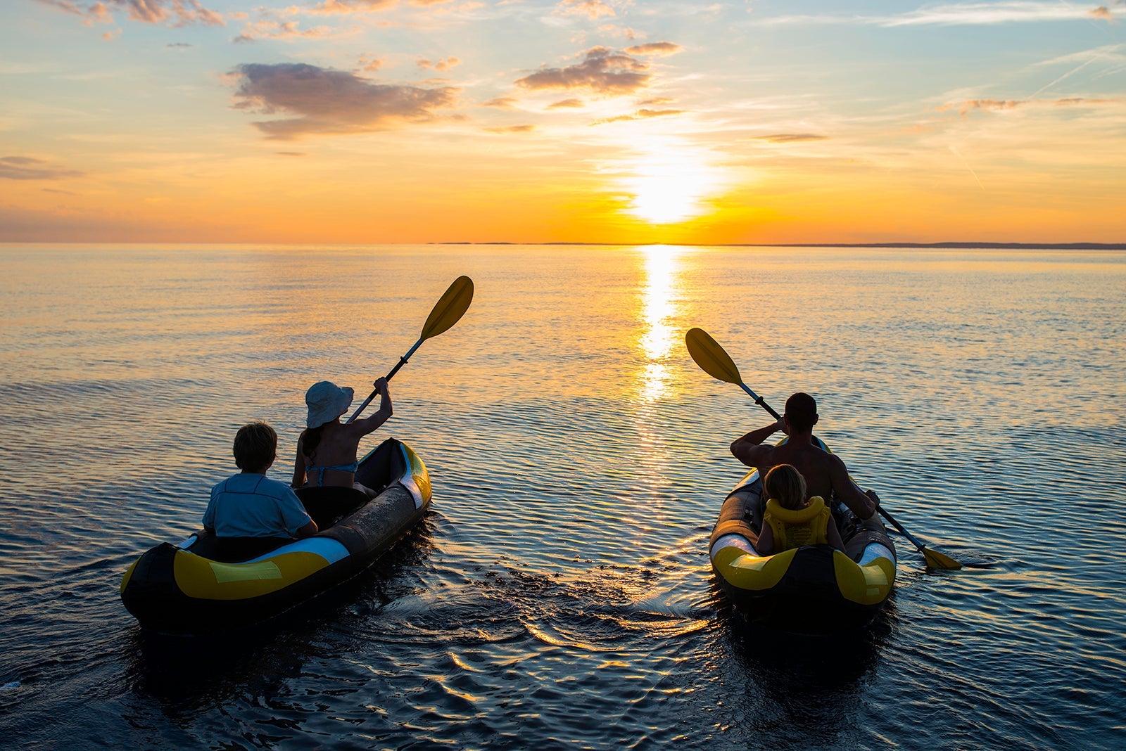Family enjoying the sunset kayak tour. (Photo by simonkr/ Getty Images)