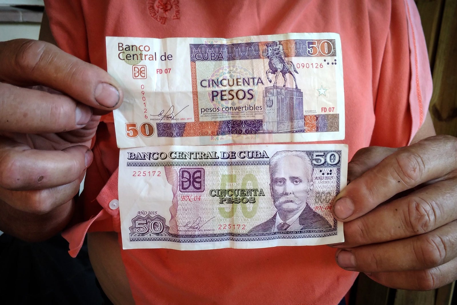 50 CUP (Cuban pesos; bottom) and 50 CUC (Cuban convertible pesos; top). (Photo by ADALBERTO ROQUE/AFP/Getty Images)