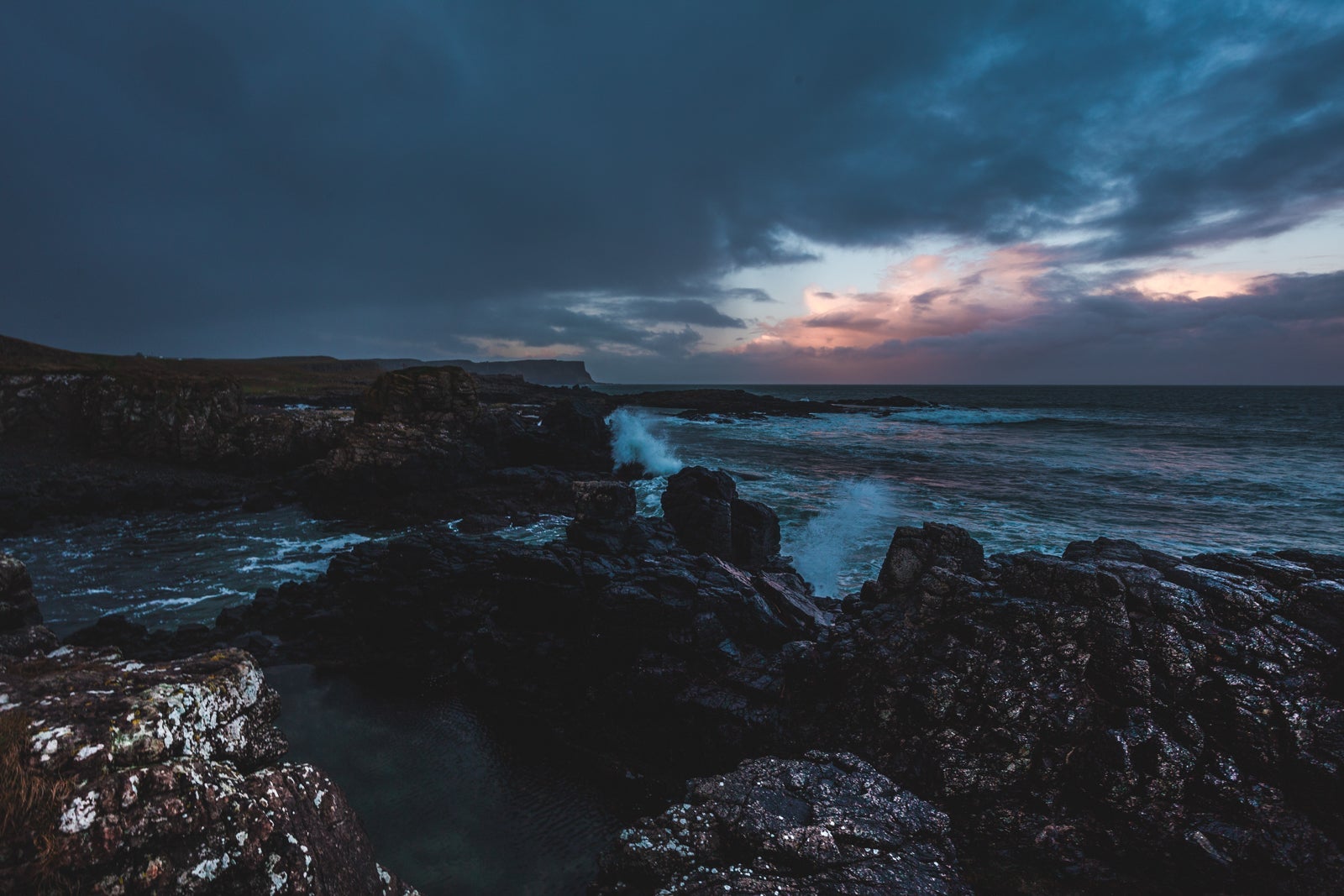 Part of the Causeway Coast in Dunserverick, UK. (Photo by Thom Holmes / Unsplash)