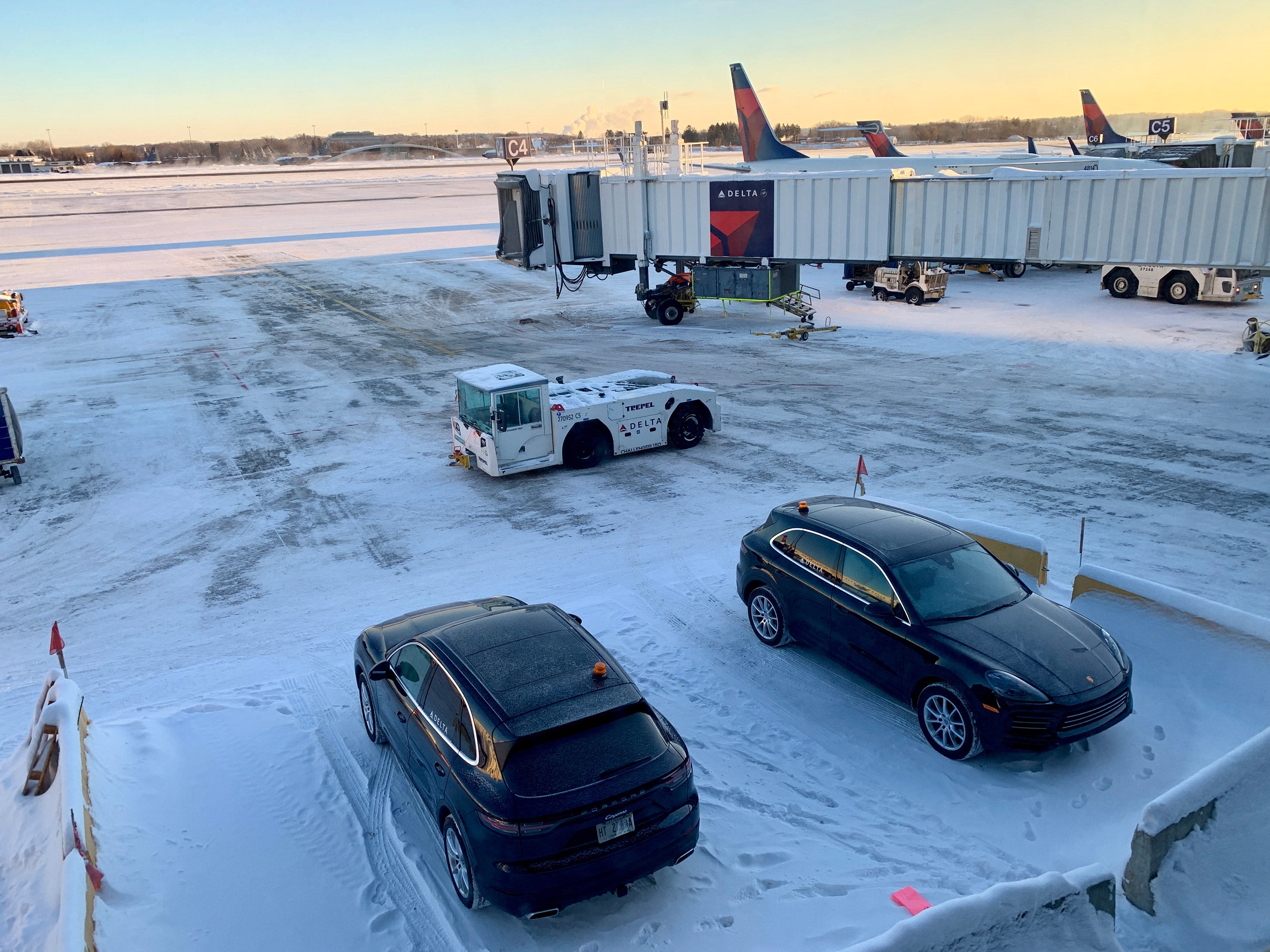 A pair of Porsche SUVs on call to shuttle top-tier Delta fliers to their connecting flights
