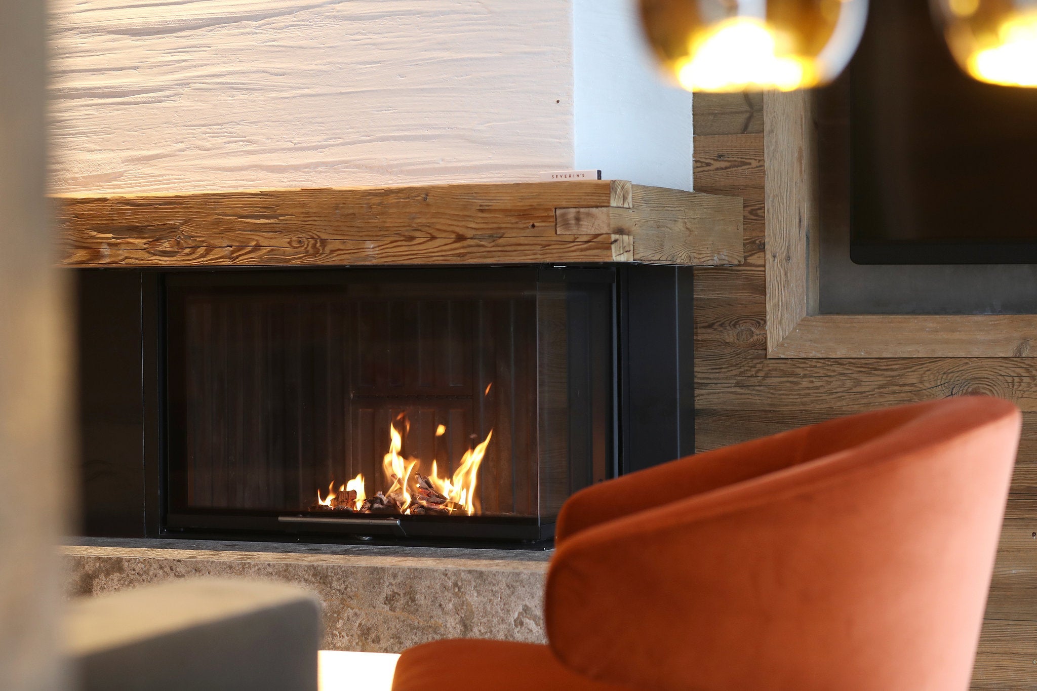 Cozy up to a fire in your Austrian junior suite at Severin's The Alpine Retreat. (Photo courtesy of SLH)