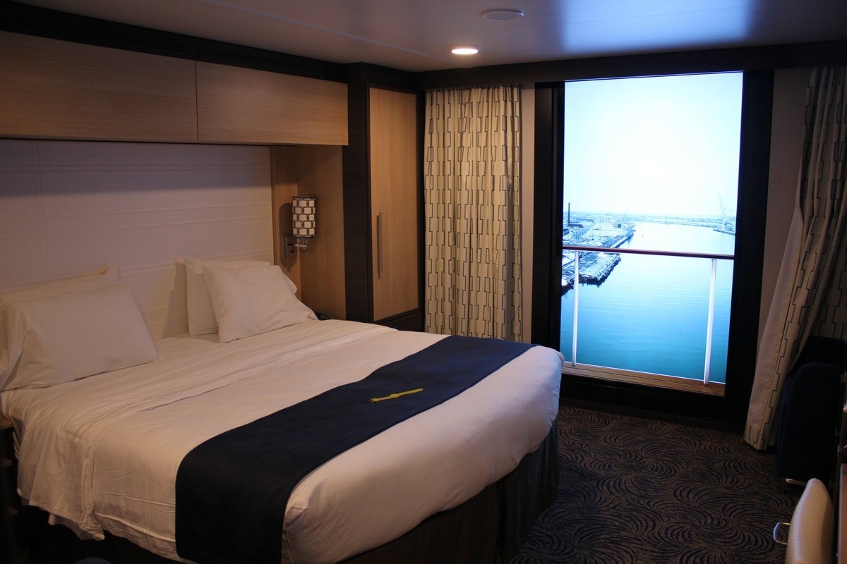 A cruise ship inside cabin with a giant LED screen instead of a balcony door