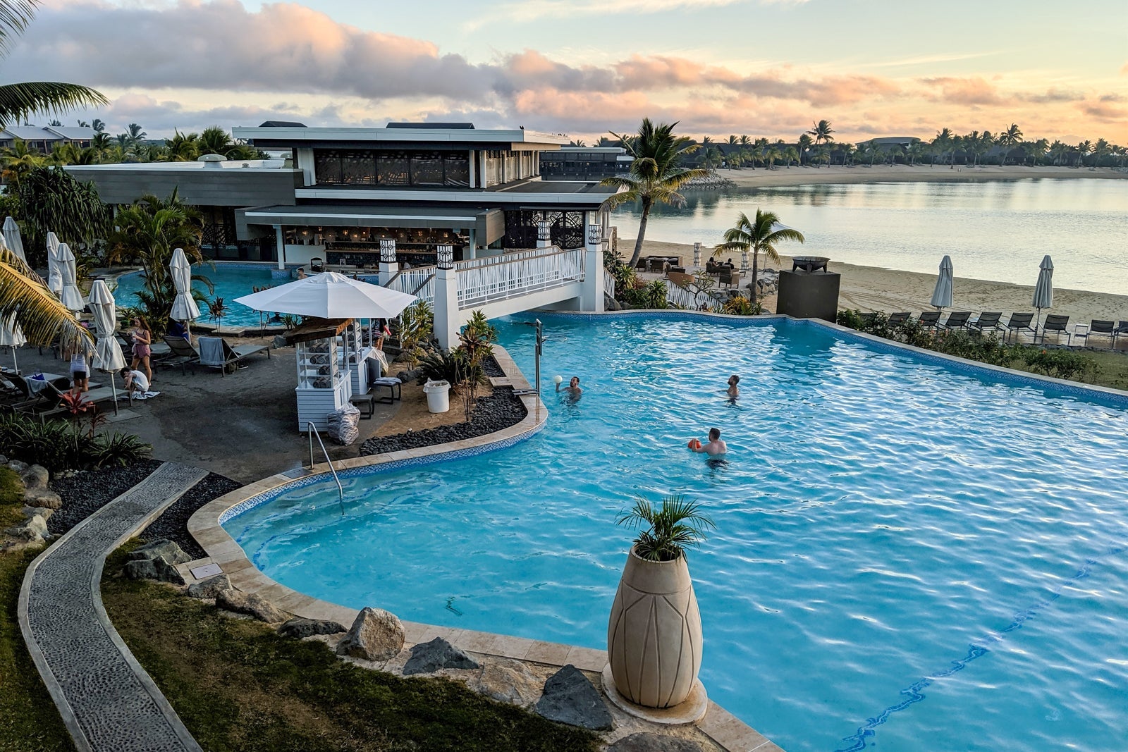 sunset behind a hotel pool