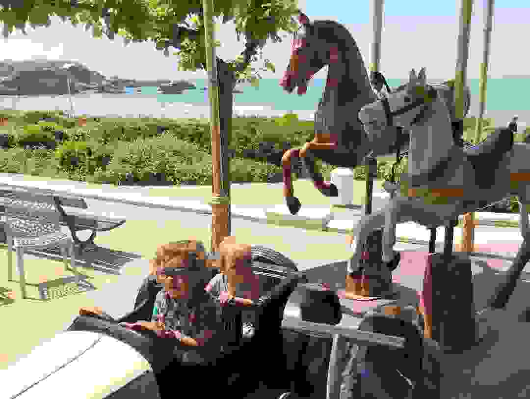 The author's kids riding a carousel they'll likely never remember in Biarritz, France (Terry-Ward.com)