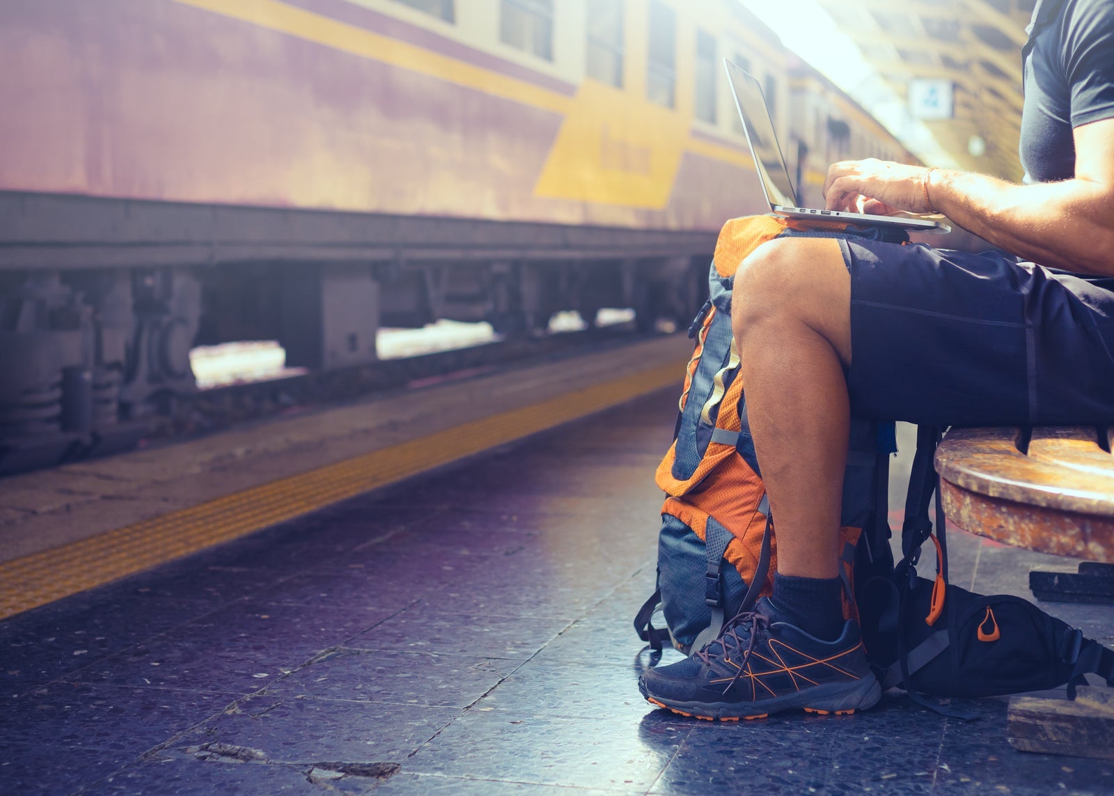 Digital nomad backpacker computer train station