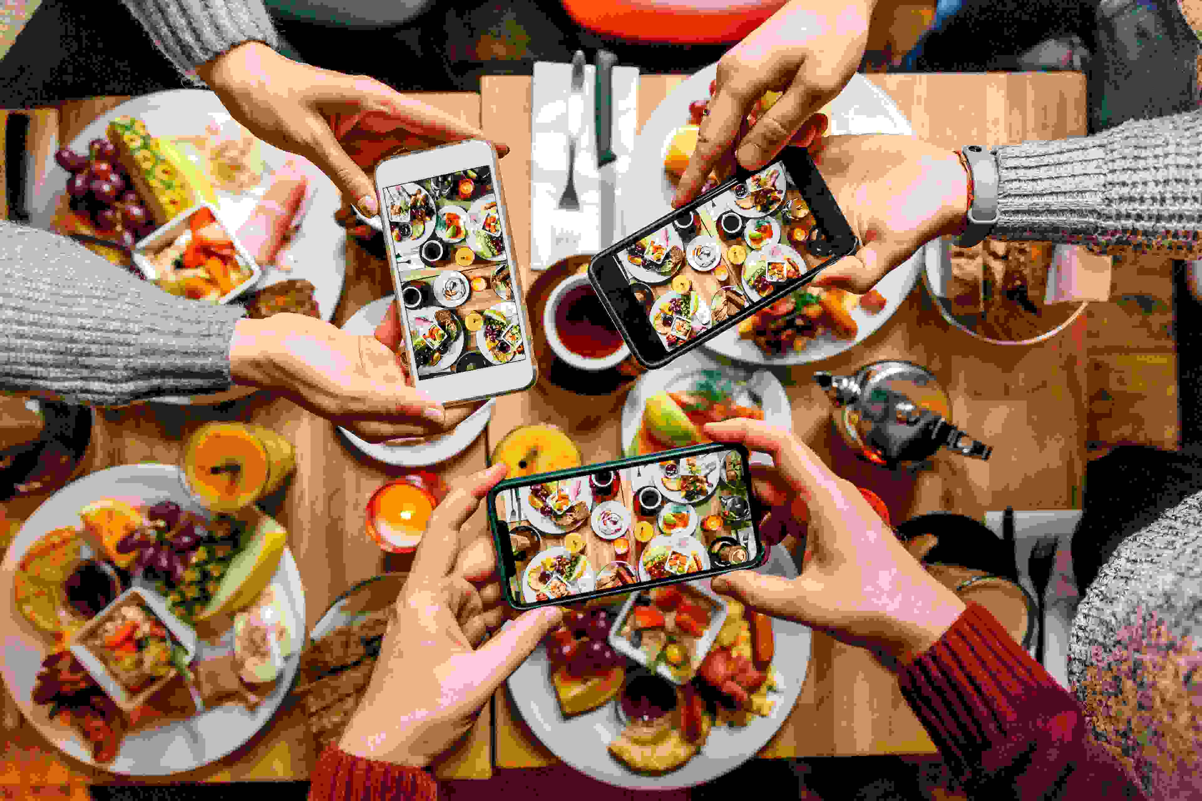 United Business vs. Club Business: Which should you get? People taking photos of their food