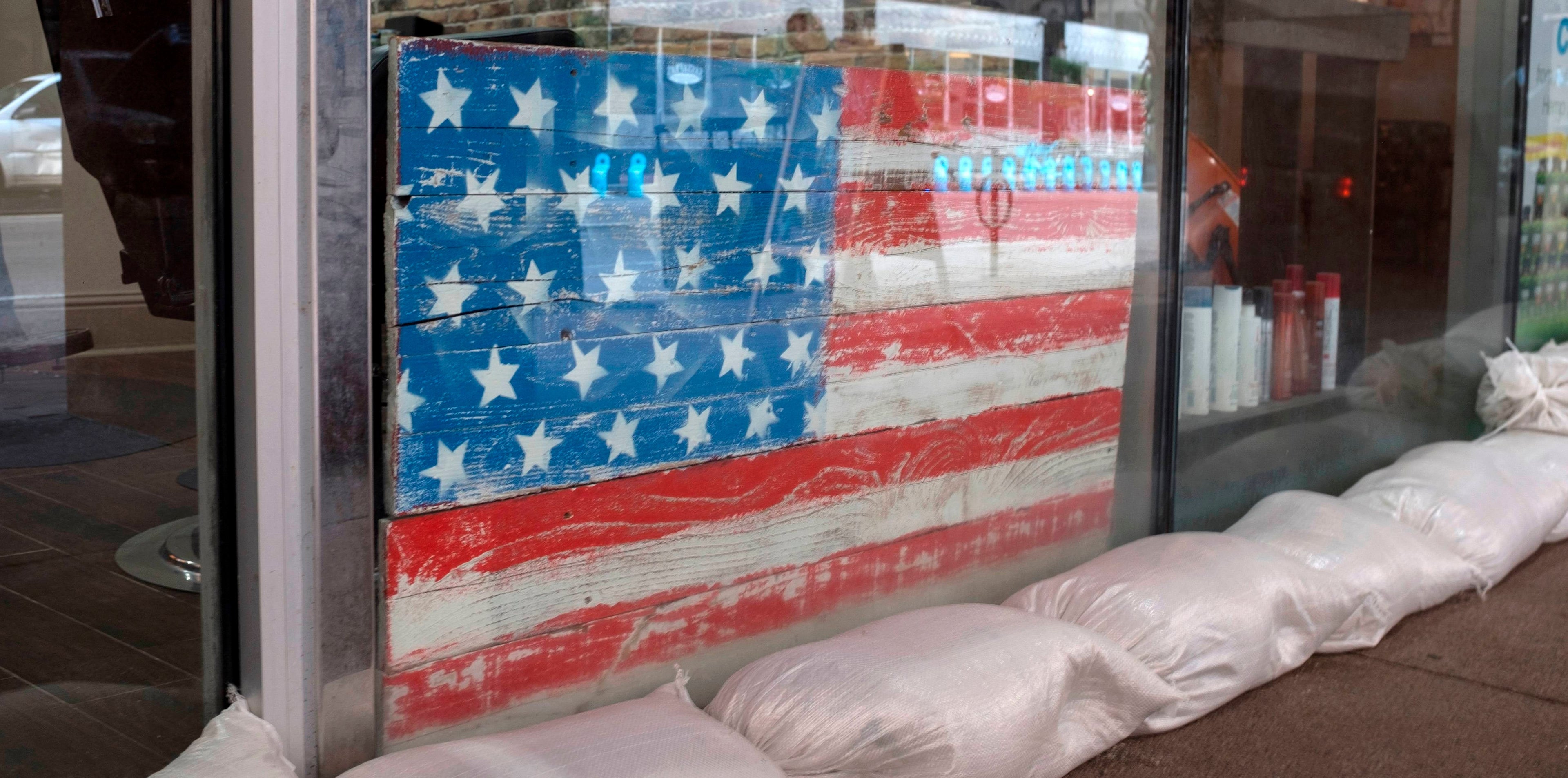 Sandbags line store front of a barber shop in preparation for tropical storm Barry in New Orleans, Louisiana, on July 11, 2019. - Tropical storm Barry barreled toward rain-soaked New Orleans on July 11 as the city hunkered down for an ordeal that evoked fearful memories of 2005's deadly Hurricane Katrina. Barry is predicted to become a Category 1 hurricane before making landfall Saturday with maximum winds reaching 75 mph. (Photo by Seth HERALD / AFP) (Photo credit should read SETH HERALD/AFP/Getty Images)