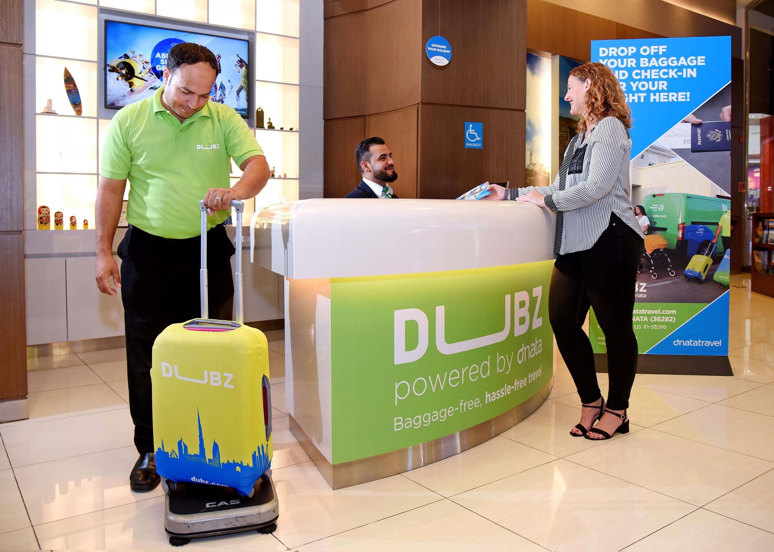 Dnata's Dubz checks in passengers for flights in The Dubai Mall
