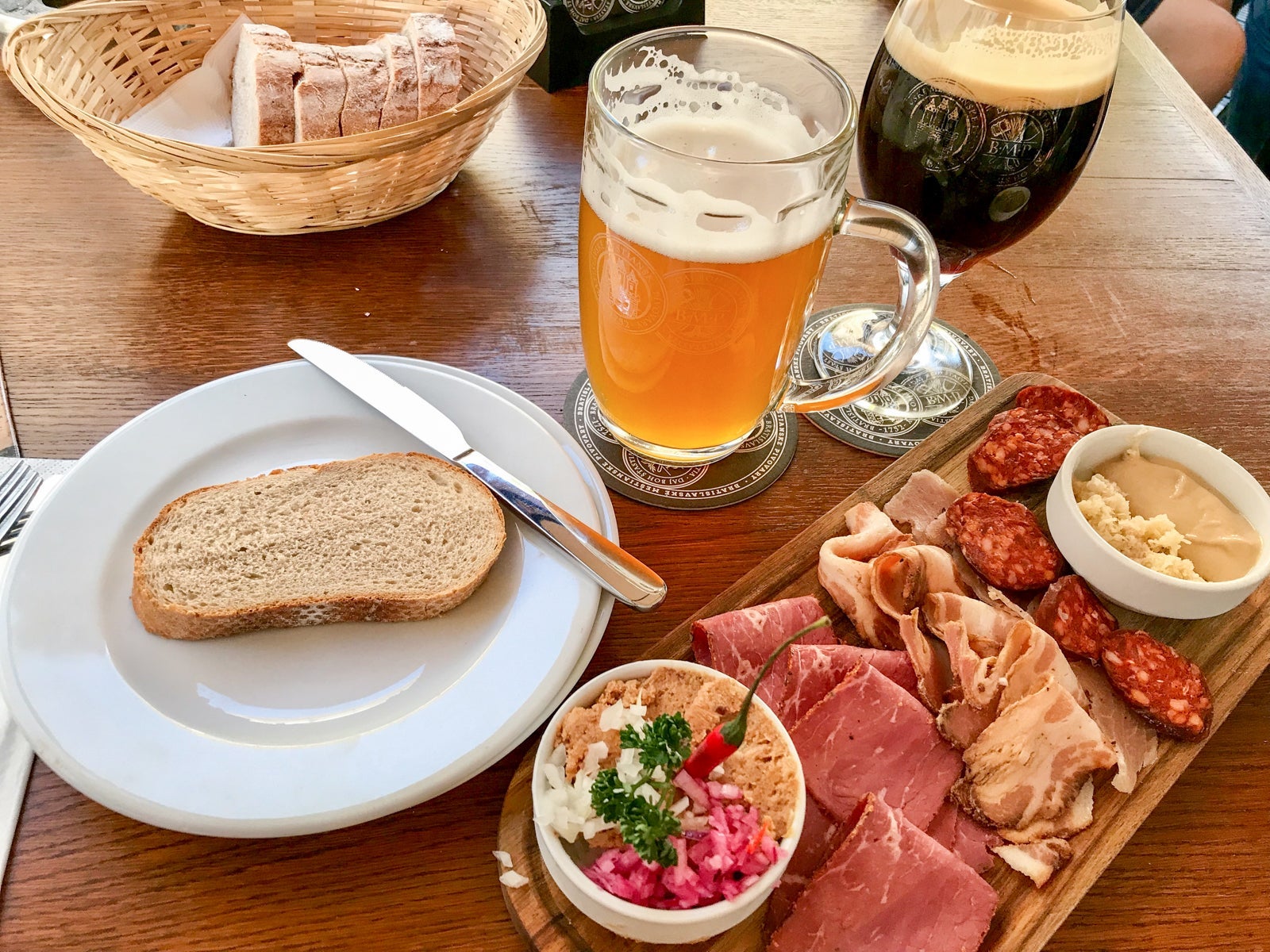 Plates of homemade sausage, juniper bacon and other meats are among the food options at Bratislava Meštiansky Pivovar.Photo by Gene Sloan / The Points Guy