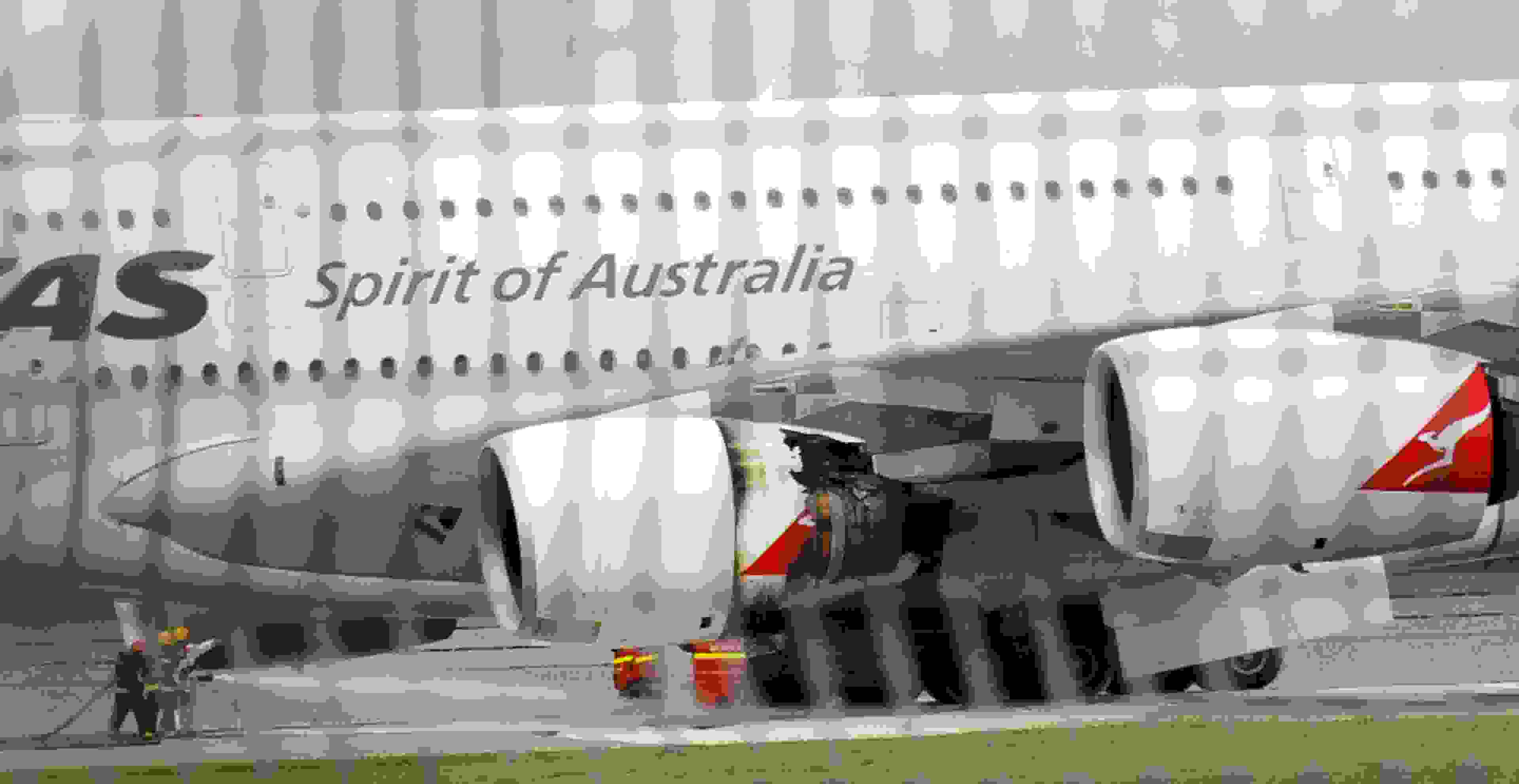 A troubled Qantas Airbus A380 plane seen after an emergency landing at the Changi International airport in Singapore on November 4, 2010. The troubled Qantas Airbus A380 plane made an emergency landing in Singapore with smoke coming out of its underside and was quickly surrounded by six fire engines. AFP PHOTO/ROSLAN RAHMAN (Photo credit should read ROSLAN RAHMAN/AFP/Getty Images)