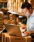 Business owner on his laptop doing inventory